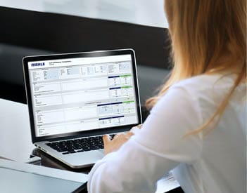 Back view of businesswoman speak using Webcam conference on laptop with diverse colleagues, female employee talk on video call with multiracial coworkers engaged in online briefing from home