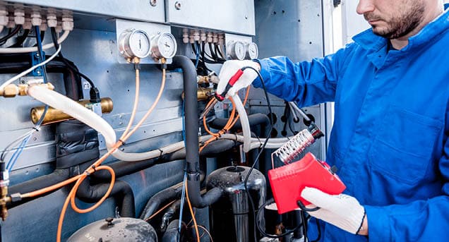 The technician repair electronic temperature sensors with an electronic soldering iron.