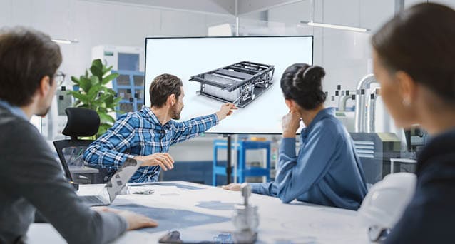 Modern Factory Office Meeting Room: Diverse Team of Engineers, Managers and Investors Talking at Conference Table, Use Interactive TV, Analyze Sustainable Energy Engine Blueprints. High-Tech Facility